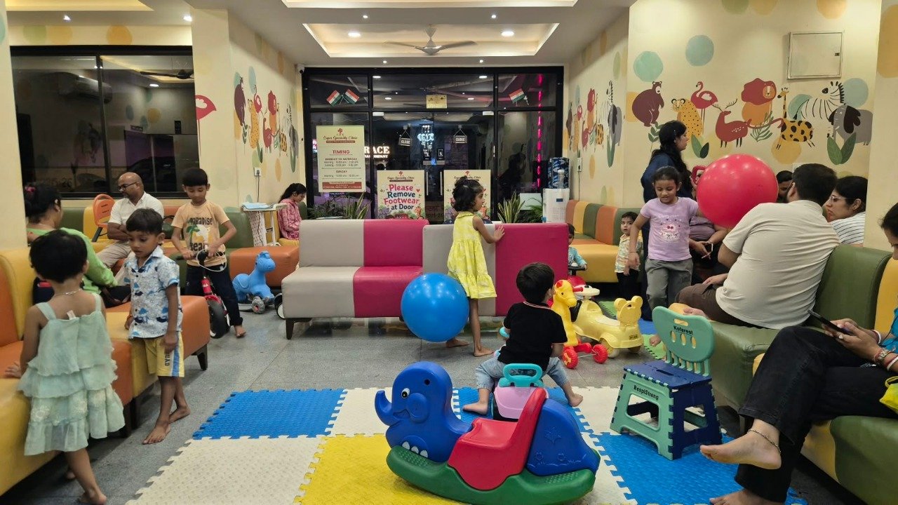 Clinic play area with colorful seating and ride-on toys